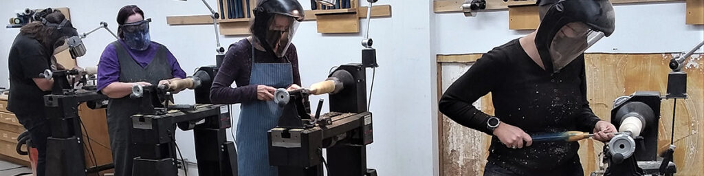 four women working at lathes